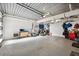 Spacious garage featuring sealed flooring, ample storage, and an organized layout at 6015 Kipps Colony E Dr, Gulfport, FL 33707