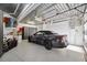 View of the garage featuring a sealed floor with a gray convertible car at 6015 Kipps Colony E Dr, Gulfport, FL 33707