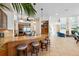 Well-appointed kitchen with breakfast bar, stainless steel appliances, and views into living spaces at 6015 Kipps Colony E Dr, Gulfport, FL 33707