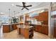 Open kitchen with wood cabinetry, granite countertops, and a spacious island with seating at 6015 Kipps Colony E Dr, Gulfport, FL 33707