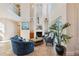Cozy living room features a fireplace, high ceilings and comfortable seating arrangements at 6015 Kipps Colony E Dr, Gulfport, FL 33707
