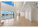 Spacious living room with tile flooring, water view and large windows that let in plenty of natural light at 6015 Kipps Colony E Dr, Gulfport, FL 33707
