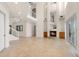 Open-concept living area with a fireplace, high ceilings, and large windows offering plenty of sunlight at 6015 Kipps Colony E Dr, Gulfport, FL 33707
