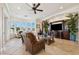 Bright living room features large windows offering waterfront views at 6015 Kipps Colony E Dr, Gulfport, FL 33707
