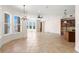 Expansive living area with bay windows overlooking the waterfront, adjacent to a kitchen and dining space at 6015 Kipps Colony E Dr, Gulfport, FL 33707