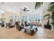 Open-concept living room featuring large windows, comfortable seating, and a view of the waterfront at 6015 Kipps Colony E Dr, Gulfport, FL 33707
