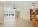 Bright and airy living room featuring bay windows with water views, seamlessly connecting to an open kitchen at 6015 Kipps Colony E Dr, Gulfport, FL 33707