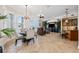 Expansive living space with dining area, seating, and wet bar with water views at 6015 Kipps Colony E Dr, Gulfport, FL 33707