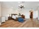 Spacious main bedroom with hardwood floors, ceiling fan, and serene decor, offering a peaceful retreat within the home at 6015 Kipps Colony E Dr, Gulfport, FL 33707
