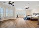 Spacious main bedroom with hardwood floors, bay window, ceiling fan, and serene decor for a comfortable retreat at 6015 Kipps Colony E Dr, Gulfport, FL 33707