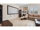 Media room with large screen, comfortable seating, and tile flooring for entertainment at 6015 Kipps Colony E Dr, Gulfport, FL 33707