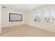 Media room featuring a large screen, tile floors, and natural light from shuttered windows at 6015 Kipps Colony E Dr, Gulfport, FL 33707