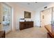 Stylish office with a rustic wood cabinet, neutral walls, and a glass door leading to the patio at 6015 Kipps Colony E Dr, Gulfport, FL 33707