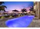 This waterfront home boasts a sparkling pool, lounge area, and views of the sunset at 6015 Kipps Colony E Dr, Gulfport, FL 33707