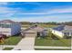 Tan two-story house with solar panels and landscaped yard at 7963 Sail Clover Ln, Zephyrhills, FL 33540