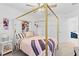 Stylish bedroom featuring a gold canopy bed and closet at 8280 Rolling Tides Dr, New Port Richey, FL 34655
