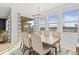 Bright dining room with a chandelier and lake view at 8280 Rolling Tides Dr, New Port Richey, FL 34655