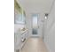 Bright entryway with white walls, wood-look floors, and a console table at 8280 Rolling Tides Dr, New Port Richey, FL 34655