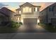 Two story house exterior at dusk at 8280 Rolling Tides Dr, New Port Richey, FL 34655