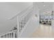 White staircase with gray carpeting and a white railing at 8280 Rolling Tides Dr, New Port Richey, FL 34655