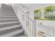 Modern staircase with grey carpet and white railing at 8280 Rolling Tides Dr, New Port Richey, FL 34655