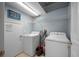 Convenient laundry room with washer, dryer, and ample shelving at 8315 Round Leaf Ln, Riverview, FL 33578