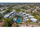 Aerial showing community, tennis court, pool, and water at 9386 Tradewinds Ave, Seminole, FL 33776