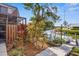 Waterfront backyard with private dock, lush landscaping, and canal views at 9386 Tradewinds Ave, Seminole, FL 33776