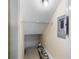 Small basement storage area with shelving and electrical panel at 9386 Tradewinds Ave, Seminole, FL 33776