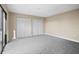 Bright bedroom with gray carpeting and double closets at 9386 Tradewinds Ave, Seminole, FL 33776