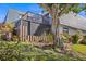 Charming home exterior with a screened lanai, a fenced yard, and beautiful landscaping at 9386 Tradewinds Ave, Seminole, FL 33776