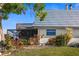 View of the back exterior with deck and landscaping at 9386 Tradewinds Ave, Seminole, FL 33776