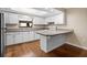 Modern kitchen featuring white cabinets, granite countertops, and stainless steel appliances at 9386 Tradewinds Ave, Seminole, FL 33776