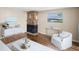 Living room with stone fireplace and hardwood floors at 9386 Tradewinds Ave, Seminole, FL 33776