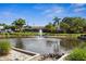 Community pond with fountain and landscaping at 9386 Tradewinds Ave, Seminole, FL 33776