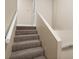 Carpeted stairway with neutral colored walls at 9386 Tradewinds Ave, Seminole, FL 33776