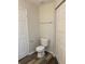 Simple and clean bathroom with toilet and flooring at 9738 Lake Chase Island Way, Tampa, FL 33626