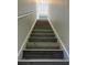 Modern staircase with wood-look laminate flooring at 9738 Lake Chase Island Way, Tampa, FL 33626