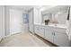 Bathroom with double vanity, large mirror, and walk-in shower at 108 Lilyan Ct, Rotonda West, FL 33947