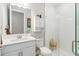 Well-lit bathroom with white cabinets, quartz countertop, and glass-enclosed shower at 14672 Horse Trot Rd, Lithia, FL 33547