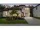 Charming two-story home with a well-lit entrance, lush landscaping, and a two-car garage at 14672 Horse Trot Rd, Lithia, FL 33547