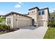 Beautiful two-story home featuring a three-car garage, manicured landscaping, and a neutral color palette at 14672 Horse Trot Rd, Lithia, FL 33547