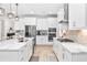 Modern kitchen featuring white cabinets, quartz countertops, stainless steel appliances, and tile backsplash at 14672 Horse Trot Rd, Lithia, FL 33547