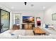 Comfortable living room with contemporary decor, sliding glass doors, and plank flooring at 14672 Horse Trot Rd, Lithia, FL 33547