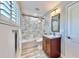 Well-lit bathroom with marble tile shower, sleek vanity, and modern fixtures at 1957 Whitney Oaks Blvd, Clearwater, FL 33760