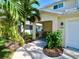 Charming front porch area with a bench, lush landscaping, and manicured lawn at 1957 Whitney Oaks Blvd, Clearwater, FL 33760