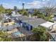 Aerial view of a light gray house with a pool, shed, and tropical landscaping at 200 140Th E Ave, Madeira Beach, FL 33708