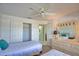 Bright bedroom featuring two twin beds, closet, neutral carpet, and a ceiling fan at 201 Silver Lake Dr # 204, Venice, FL 34292