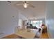 Dining room with a view of the living room, balcony, and ceiling fan at 201 Silver Lake Dr # 204, Venice, FL 34292