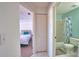 Hallway showing view of a bedroom with a bed and view of a bathroom with a toilet and shower at 201 Silver Lake Dr # 204, Venice, FL 34292